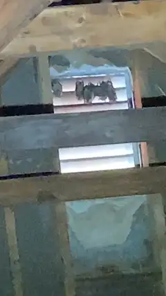 A louvered attic vent with the gap animals used to get inside